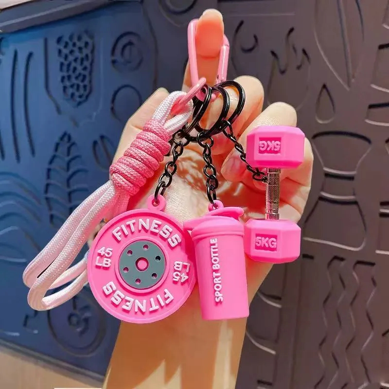 Pink fitness keychain set with FITNESS weight plate, sport bottle and 5 kg dumbbell charms